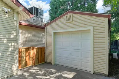 a garage with white doors next to a house at East Sac Getaway, Walking Distance to Hospitals in Sacramento