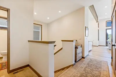 a hallway with a staircase in a house at Meadowlark in Tahoe Donner - Modern 4BR w great views, hot tub & HOA amenities in Truckee