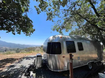 a silver trailer parked on the side of a road at Modern Airstream with amazing view - 10 to 15 minutes from Kings Canyon National Park in Dunlap