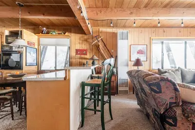 a kitchen and living room in a tiny house at Quaint Cabin in Serene Lakes - Close to Skiing! in Soda Springs