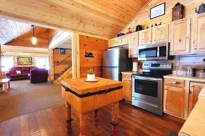 a kitchen with a stove and a table in a cabin at Sequoia Splendor, inside Kings Canyon NP by Visitors Center in Wilsonia
