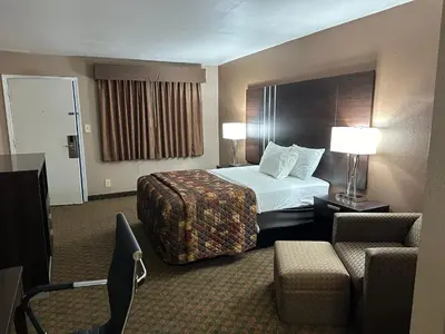 a hotel room with a bed and a chair at Star Inn in Tonopah