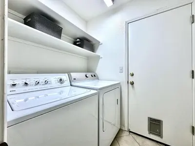 a white kitchen with a washer and dryer in it at King Bed Retreat, Pet-Friendly, Rancho Cordova in Rancho Cordova