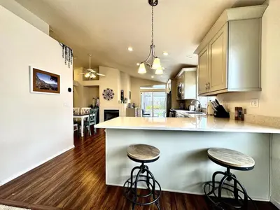 a kitchen with two stools at a kitchen counter at King Bed Retreat, Pet-Friendly, Rancho Cordova in Rancho Cordova