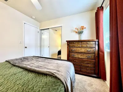 a bedroom with a bed and a dresser and a mirror at King Bed Retreat, Pet-Friendly, Rancho Cordova in Rancho Cordova