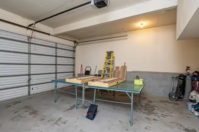 a garage with a table in the middle of a room at Tranquil Retreat - Home with Spacious Deck & Grill home in Groveland