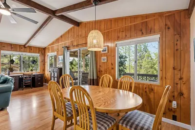 a dining room with a table and chairs at Tranquil Retreat - Home with Spacious Deck & Grill home in Groveland