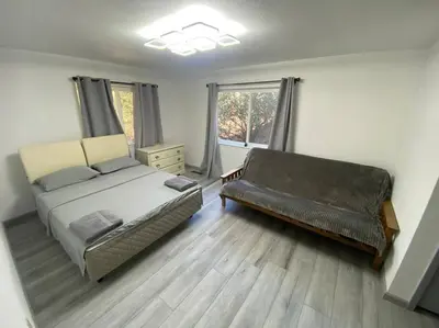 a bedroom with a bed and a couch at Scenic view villa near Yosemite in Groveland