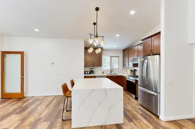 a kitchen with a white counter and a refrigerator at Forest Grove in Kings Beach