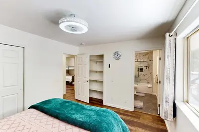 a bedroom with a bed with a green blanket at Forest Grove in Kings Beach