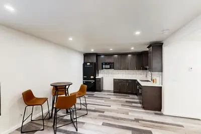 a kitchen with wooden cabinets and a table and chairs at Forest Grove in Kings Beach