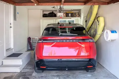 a red car parked in a garage with a surfboard at Folsom Old Town Escape in Folsom