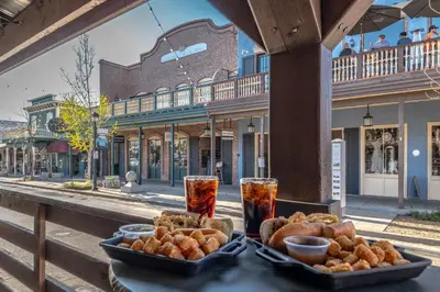 a table with a tray of bread and drinks on a street at Folsom Old Town Escape in Folsom