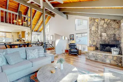 a living room with a couch and a fireplace at Making Waves, Unit B in Stateline
