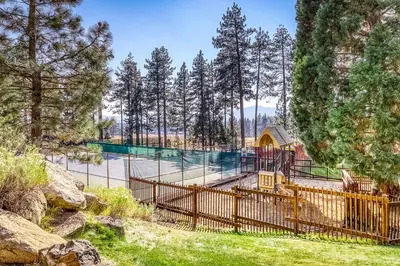a playground in a park with a fence at Making Waves, Unit B in Stateline