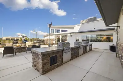 a patio with an outdoor bar with a grill at Residence Inn by Marriott Lodi Stockton in Lodi