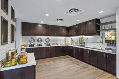 a large kitchen with wooden cabinets and wooden floors at Residence Inn by Marriott Lodi Stockton in Lodi