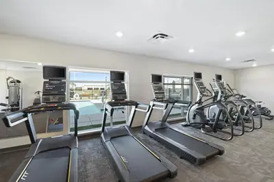 a gym with several treadmills and a row of exercise bikes at Residence Inn by Marriott Lodi Stockton in Lodi