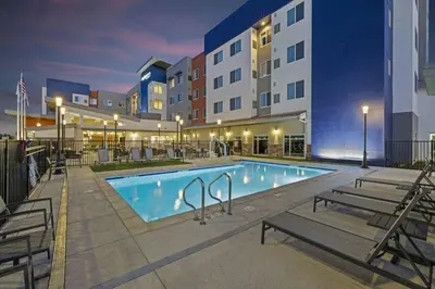 a pool at a hotel with benches around it at Residence Inn by Marriott Lodi Stockton in Lodi