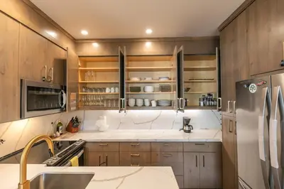 a kitchen with wooden cabinets and a refrigerator at Stylish 2BD Condo - Walk to Palisades! in Olympic Valley