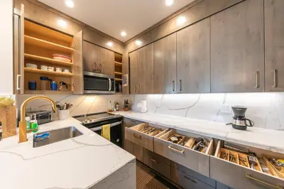 a kitchen with wooden cabinets and a sink at Stylish 2BD Condo - Walk to Palisades! in Olympic Valley