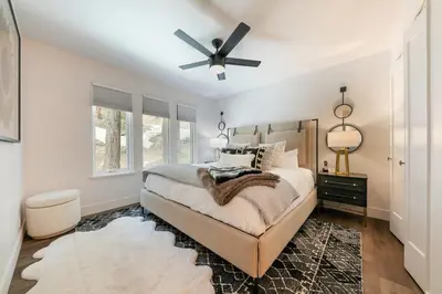 a bedroom with a bed and a ceiling fan at Stylish 2BD Condo - Walk to Palisades! in Olympic Valley