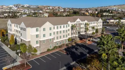 an overhead view of a building with a parking lot at Staybridge Suites Sacramento-Folsom by IHG in Folsom