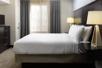 a hotel room with a bed and a window at Staybridge Suites Sacramento-Folsom by IHG in Folsom