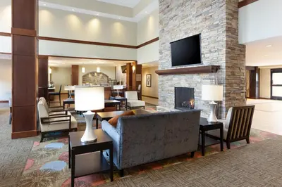 a living room with a fireplace and a tv at Staybridge Suites Sacramento-Folsom by IHG in Folsom