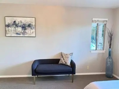 a blue couch sitting in a room with a window at Ripon Orchard Retreat in Ripon
