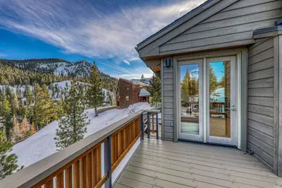 a house with a balcony with a sliding glass door at Bright 5BD Alpine Retreat - 5Min to Alpine Meadows in Tahoe City