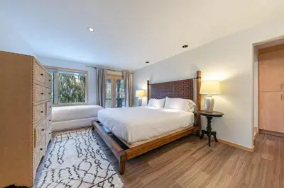 a bedroom with a large bed and a window at Bright 5BD Alpine Retreat - 5Min to Alpine Meadows in Tahoe City