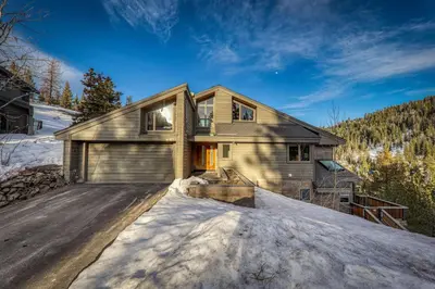 a house with a garage in the snow at Bright 5BD Alpine Retreat - 5Min to Alpine Meadows in Tahoe City