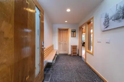 a hallway with a wooden door and a staircase at Bright 5BD Alpine Retreat - 5Min to Alpine Meadows in Tahoe City