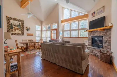 a living room with a couch and a fireplace at Hideaway Down Canyon #101 in June Lake