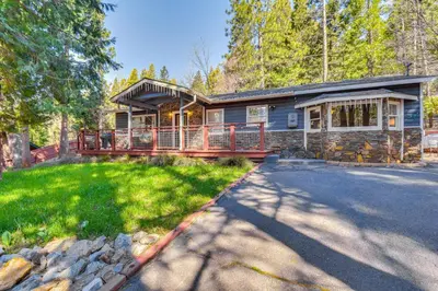 a log home with a large porch and a driveway at Lake Access and Hot Tub Pet-Friendly Arnold Home in Arnold