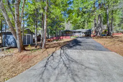 an empty road in front of a house with trees at Lake Access and Hot Tub Pet-Friendly Arnold Home in Arnold