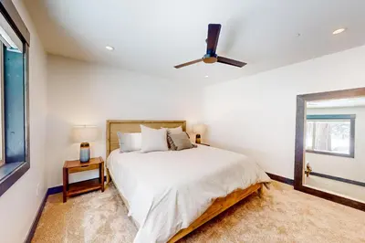 a bedroom with a bed and a ceiling fan at Mountain Majesty in Truckee