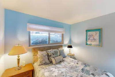 a bedroom with a bed with a window above it at Take a Peak in Incline Village