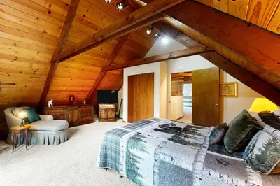 a bedroom with a bed and a wooden ceiling at Cardinal's Nest in Groveland
