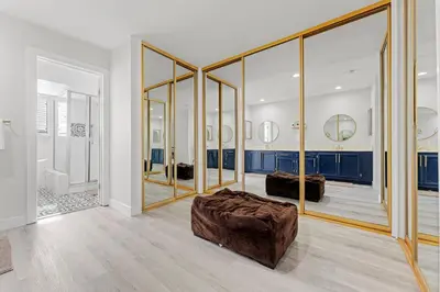 a living room with mirrors and a brown couch at * Large Updated Waterfront Delta Manor Boat Dock * in Discovery Bay