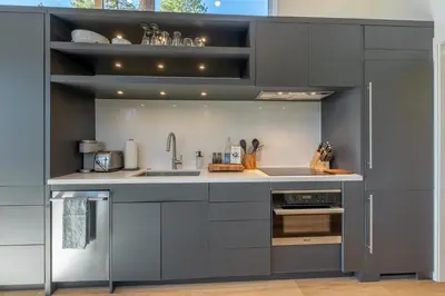 a kitchen with gray cabinets and a sink at Village Camp Truckee in Truckee