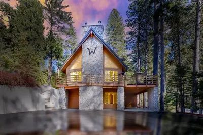 a house in the middle of a forest at WHouse*HotTub*Sleeps20*BLS*FirePit*AC&Heat*DogsOk in Arnold