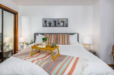 a bedroom with a bed with a table on it at WHouse*HotTub*Sleeps20*BLS*FirePit*AC&Heat*DogsOk in Arnold