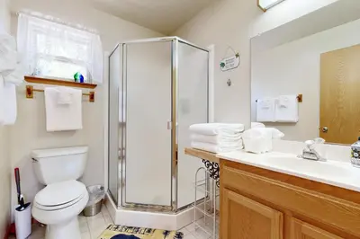 a bathroom with a shower and a toilet and a sink at Cozy Chalet in Arnold
