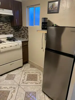 a kitchen with a refrigerator and a stove at Jerry's Motel in Oakdale