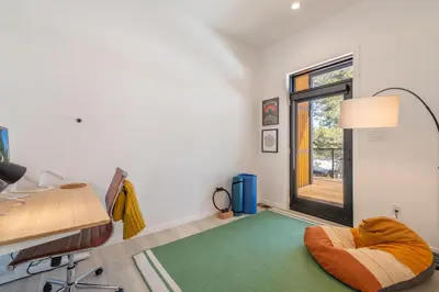a room with a desk and a bed and a window at Modern Eco Retreat with Hot Tub and Views in Truckee