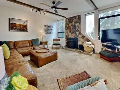 a living room with a leather couch and a flat screen tv at 1849 Condos 542 condo in Mammoth Lakes