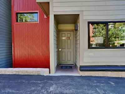 a house with a red door and a window at 1849 Condos 542 condo in Mammoth Lakes