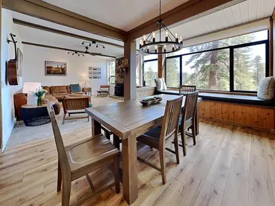 a dining room and living room with a wooden table and chairs at 1849 Condos 542 condo in Mammoth Lakes